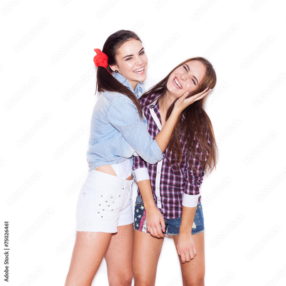 two fashion girls having fun. Young woman closes ears girlfriend two fashion girls having fun. Young woman closes ears girlfriend