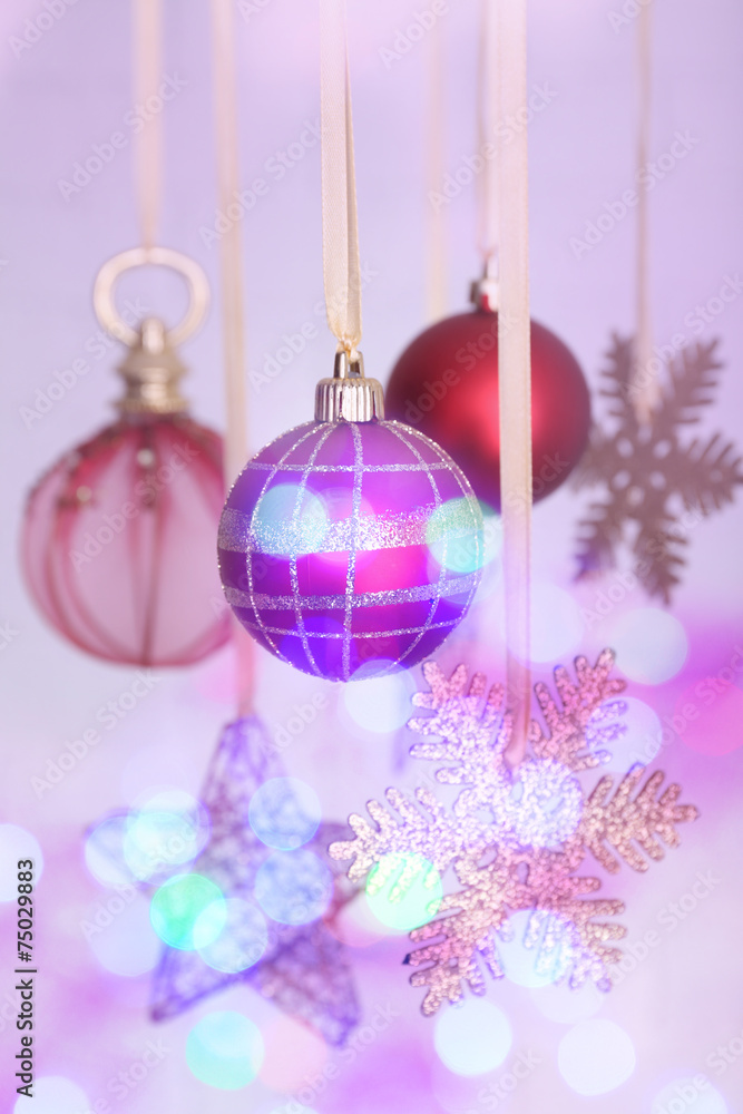 Christmas decorations hanging on festive background Christmas decorations hanging on festive background