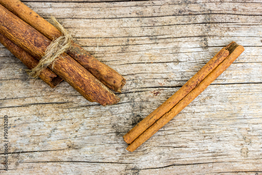 cinnamon sticks on old wooden table cinnamon sticks on old wooden table