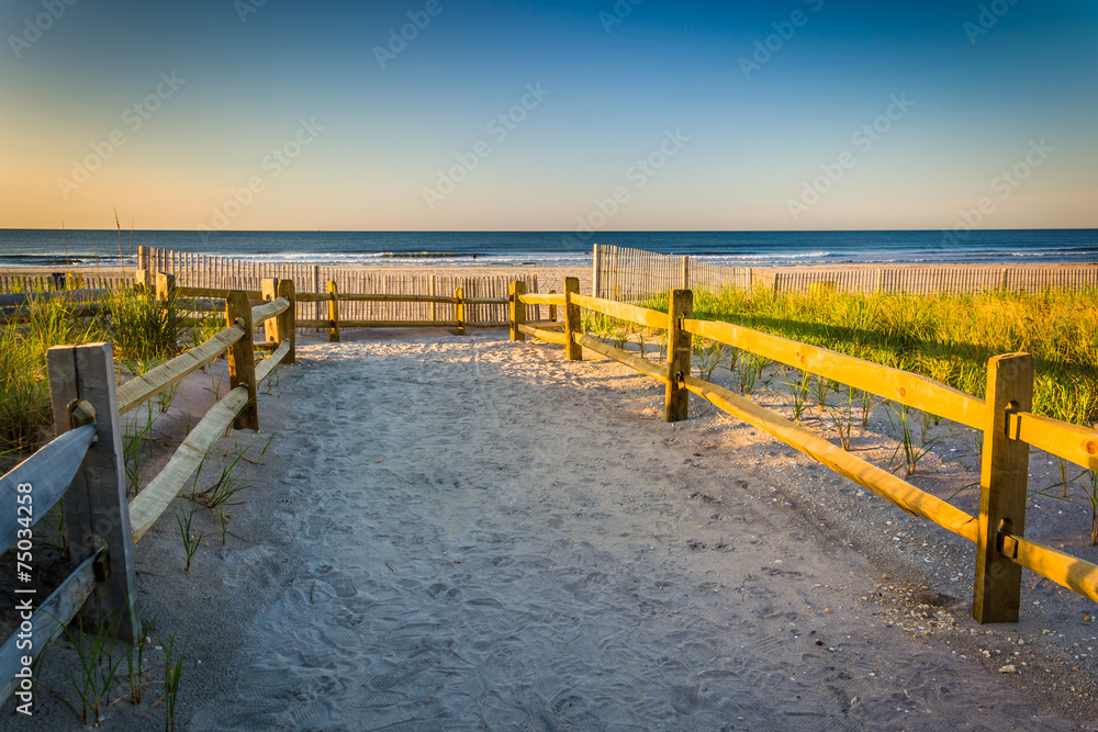 Path over sand dunes to the Atlantic Ocean at sunrise in Ventnor