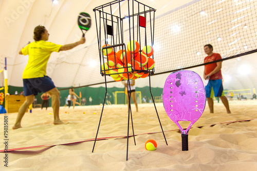 Beach tennis training on sand covered court