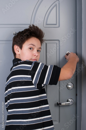 boy locks the door photo