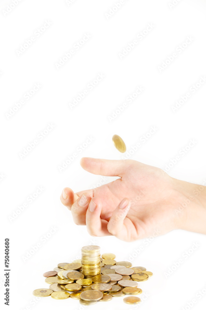 Hand catching one more coin over the stack of coins Hand catching one more coin over the stack of coins