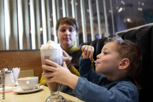 Boy eats foam of milkshake