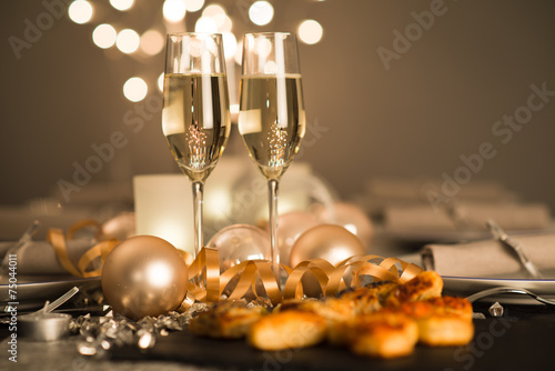 new years eve party table with champagne flute ribon glitter