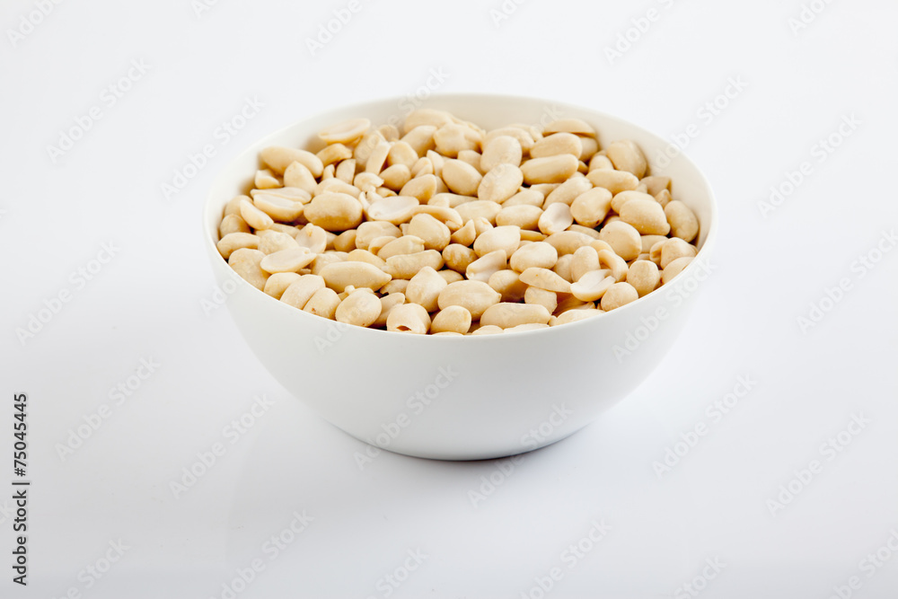 Peeled peanuts  in a white bowl
