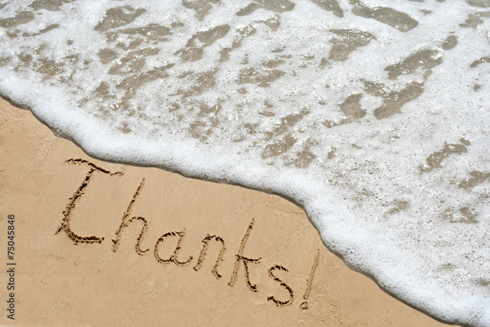 Conceptual thank you text in sand and water Conceptual thank you text in sand and water