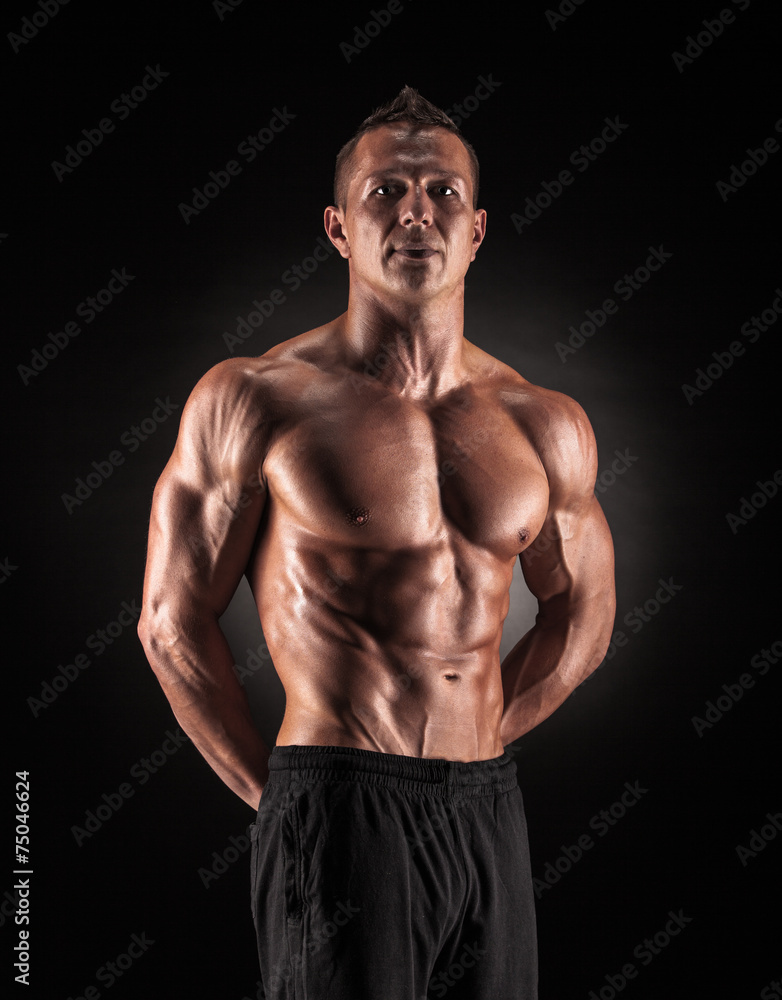 Fototapeta premium Muscular man on black background