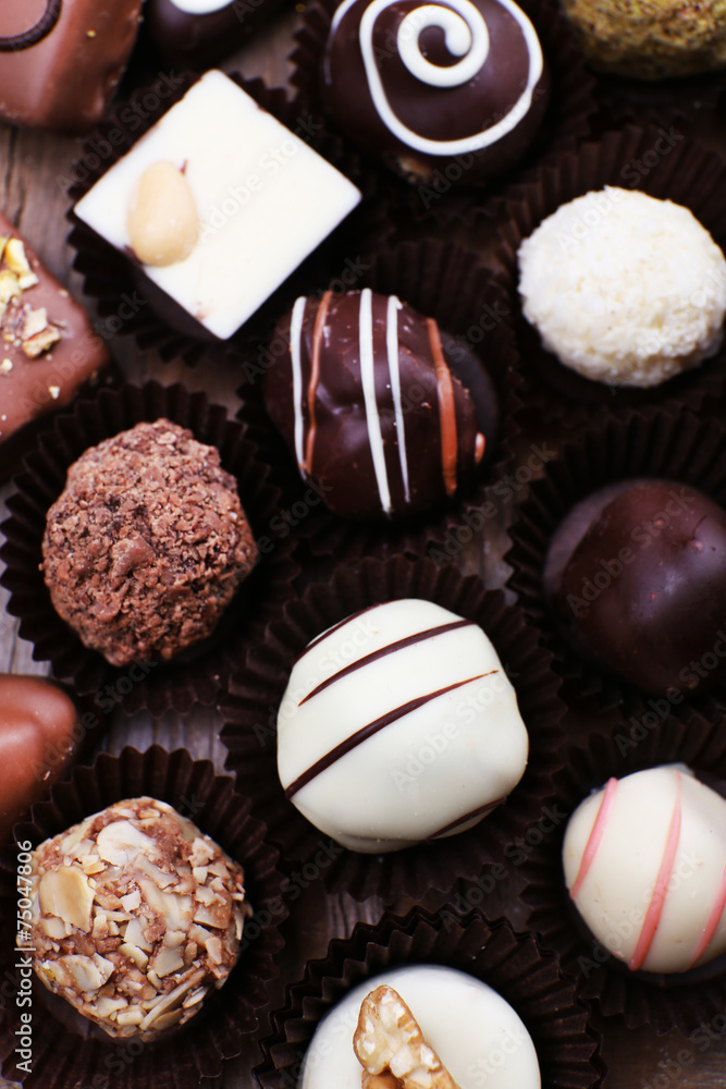 Many chocolates on wooden textured background Many chocolates on wooden textured background