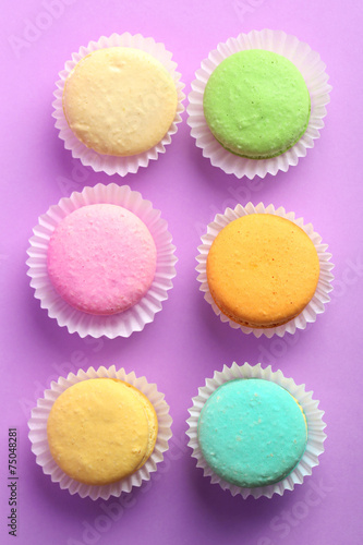 Set of gentle colorful macaroons on color background