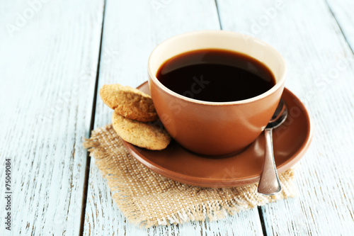 Cup of coffee with cookies and spoon