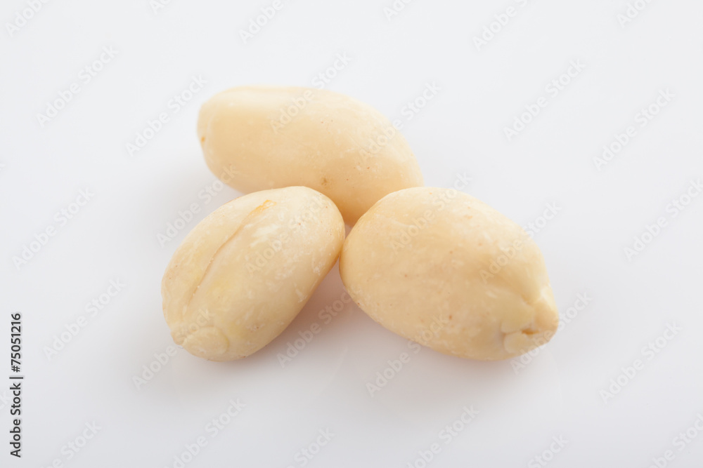 Peeled peanuts on white background