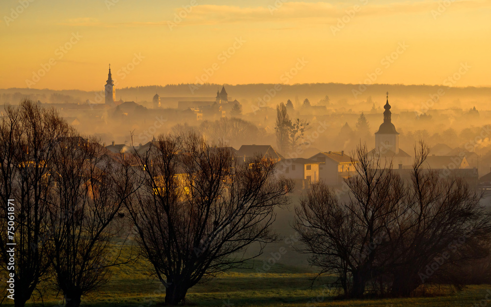 Fototapeta premium Town of Krizevci towers in fog