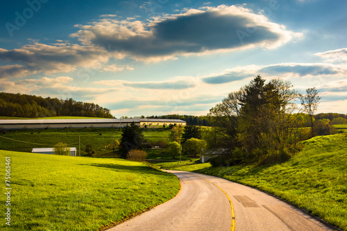 Country road and view of farm fields and rolling hills in rural