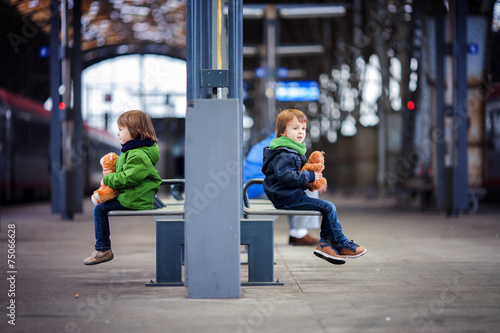Photography Two boys, sitting in a bench on the railway station