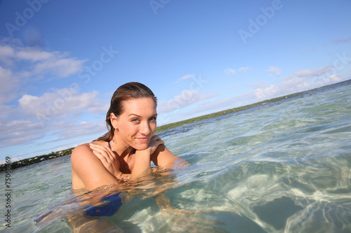 Portrait of smiling woman enjoying swimming in lagoon