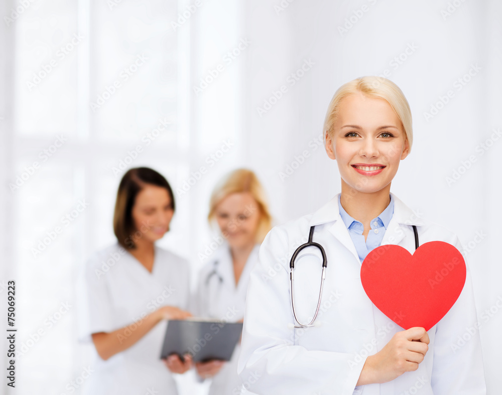 smiling female doctor with heart and stethoscope smiling female doctor with heart and stethoscope