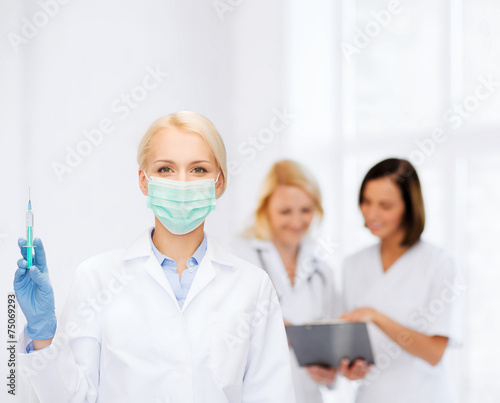 doctor in mask holding syringe with injection