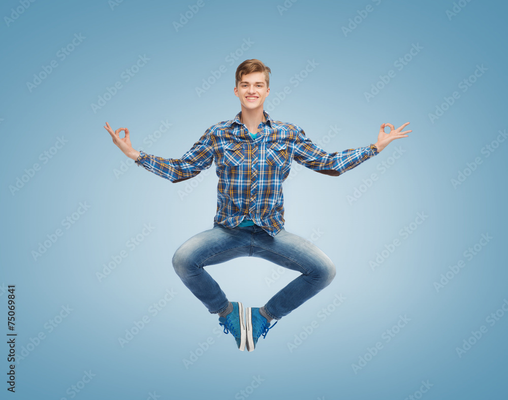 Obraz premium smiling young man jumping in air