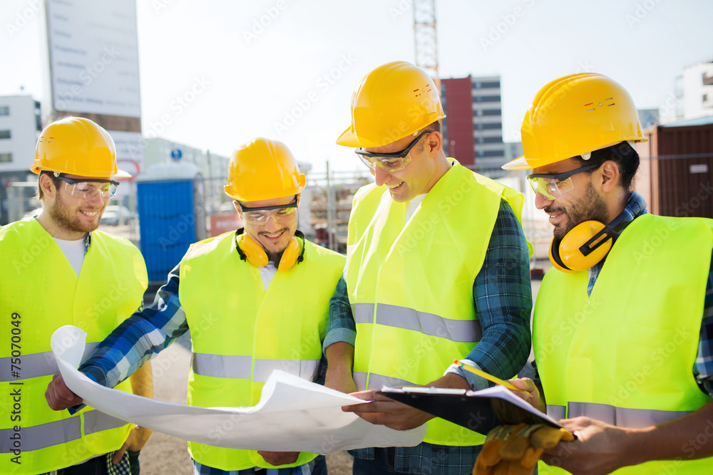 group of builders with tablet pc and blueprint group of builders with tablet pc and blueprint