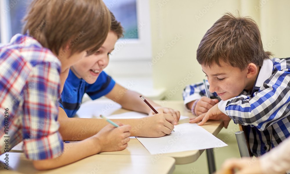 group of schoolboys writing or drawing at school group of schoolboys writing or drawing at school