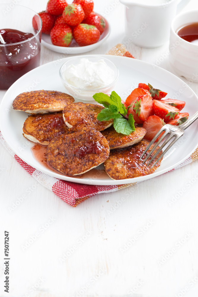 Pancakes with fresh strawberries, jam and tea Pancakes with fresh strawberries, jam and tea