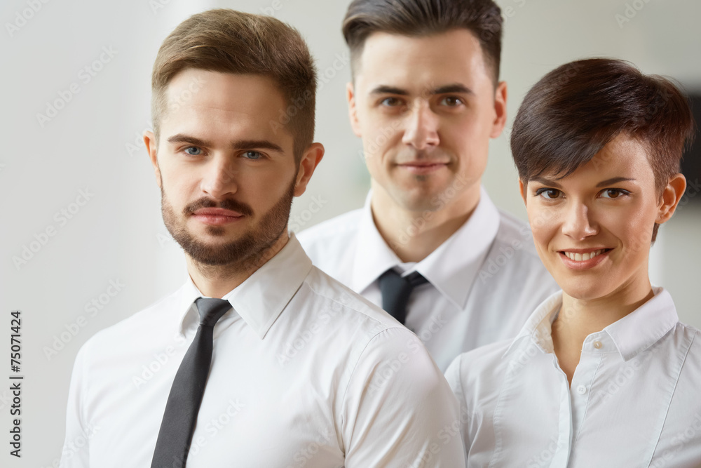 Business Team. Happy smiling people standing in office Business Team. Happy smiling people standing in office