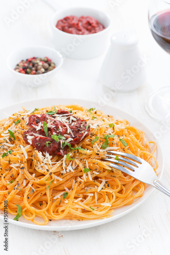spaghetti with tomato sauce and parmesan cheese on plate