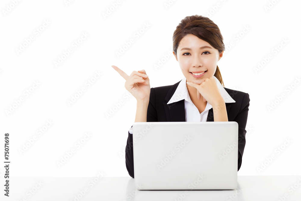 smiling young business woman working with laptop and pointing smiling young business woman working with laptop and pointing