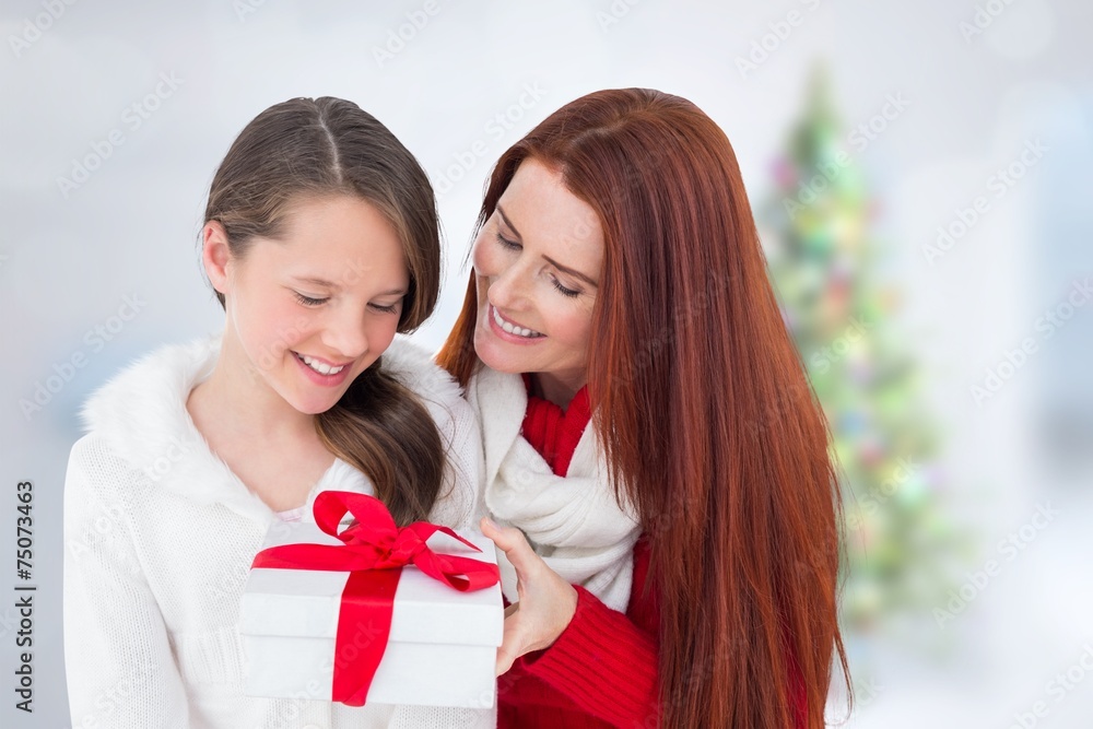 Composite image of mother and daughter with gift Composite image of mother and daughter with gift