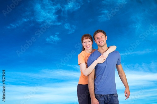 Composite image of happy couple looking at camera