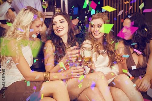 Composite image of pretty friends having a drink together