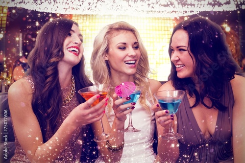 Composite image of pretty friends drinking cocktails together