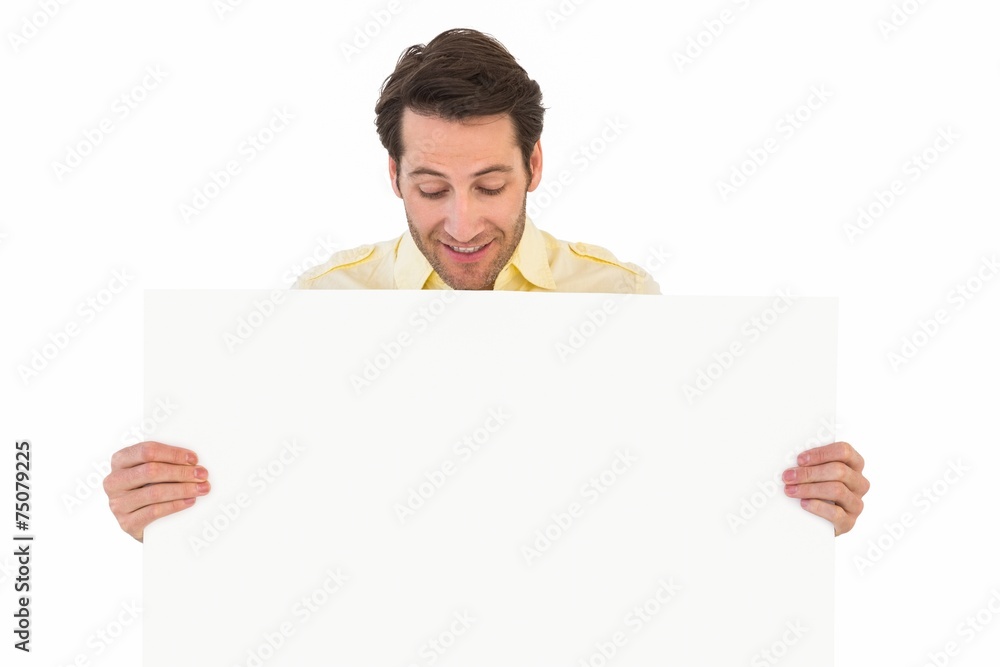 Attractive man smiling and holding poster Attractive man smiling and holding poster