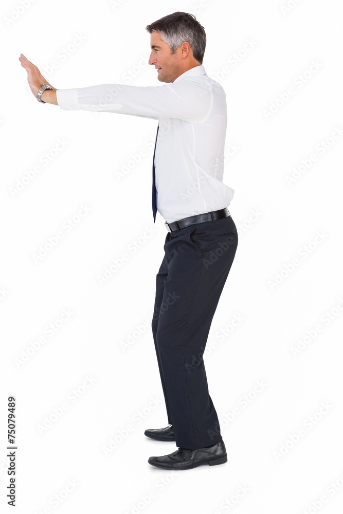 Side view of a businessman pushing Side view of a businessman pushing
