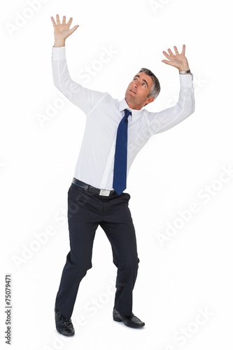 Businessman looking up with arms up