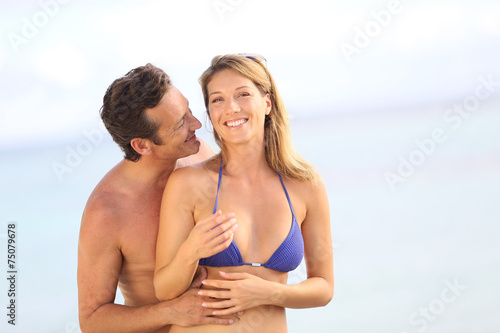 Cheerful 40-year-old couple at the beach