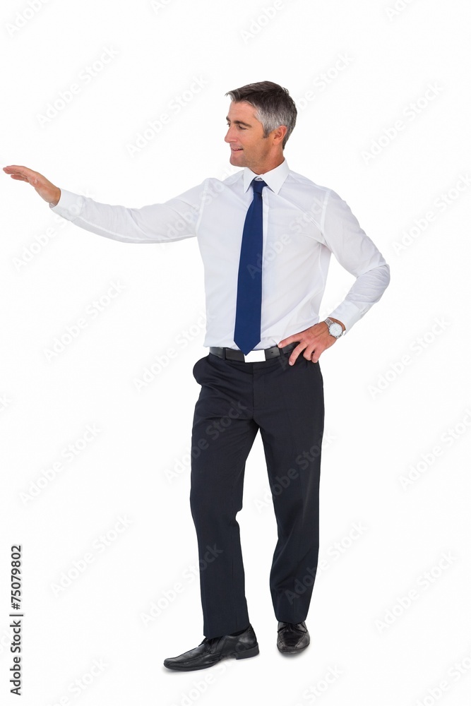 Smiling businessman with one arm out Smiling businessman with one arm out