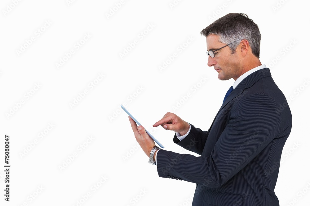 Businessman in glasses using his tablet pc