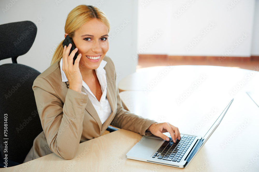 Young business woman with laptop in the office Note to editor: Young business woman with laptop in the office Note to editor: