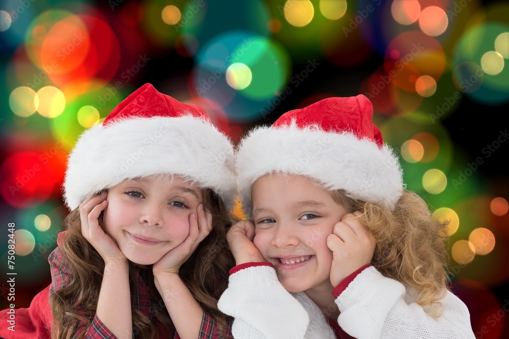 Composite image of festive little siblings smiling at camera Composite image of festive little siblings smiling at camera
