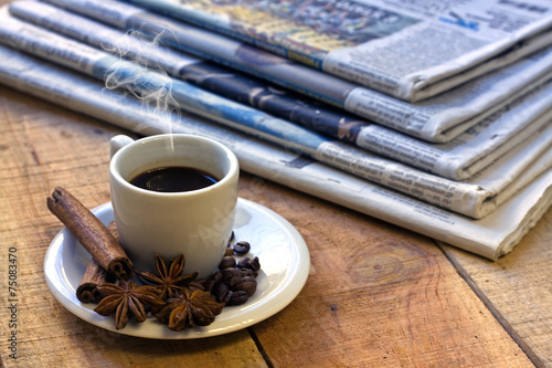 Coffee cup and newspaper photo