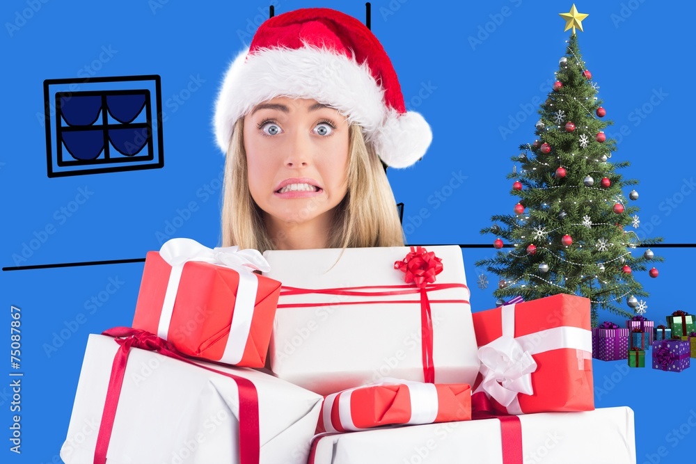 Composite image of festive blonde holding pile of gifts Composite image of festive blonde holding pile of gifts