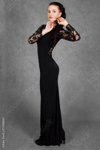 Portrait of a young attractive woman in a black evening dress