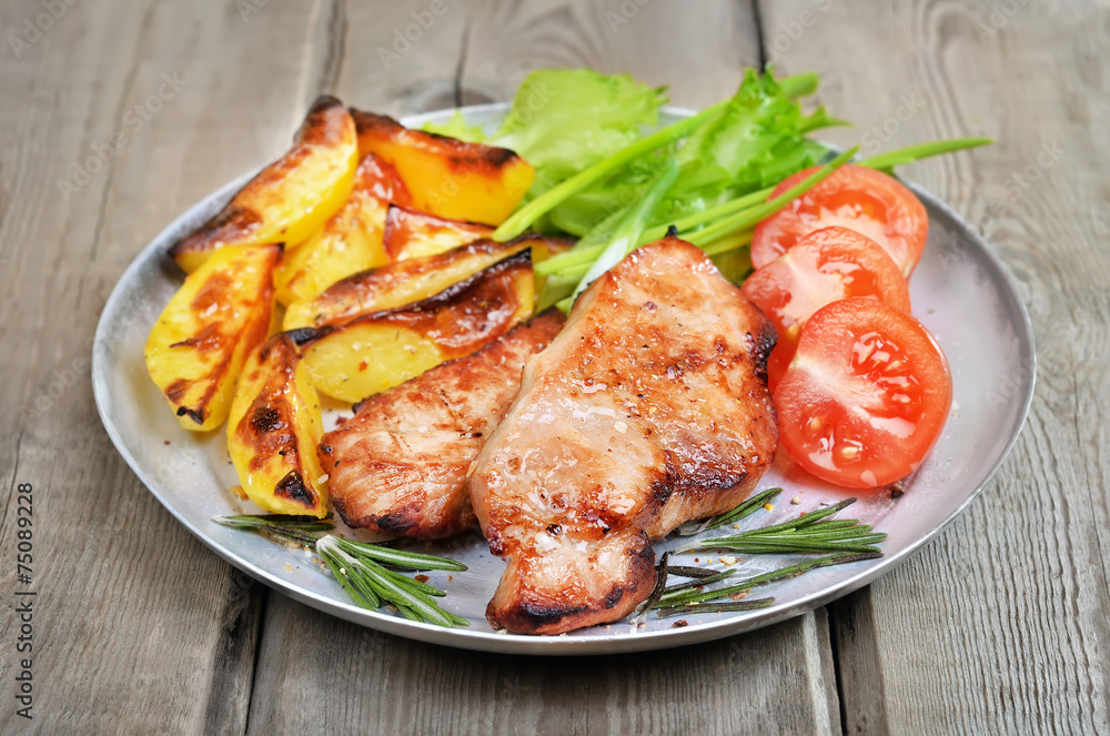 Grilled pork chop on rustic table