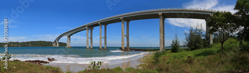 Tropical panoramic view of sea with a high bridge to an island © yarlander