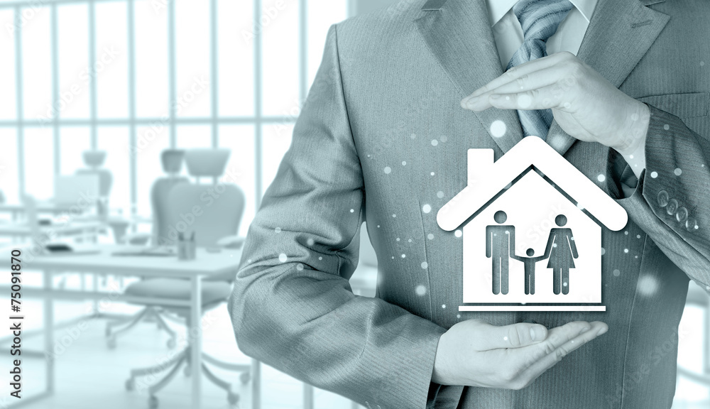 businessman protecting family in home with hands businessman protecting family in home with hands