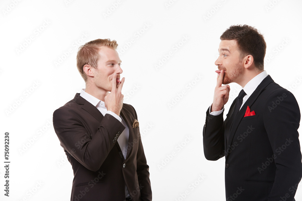 Two young men in suits talking having fun Two young men in suits talking having fun