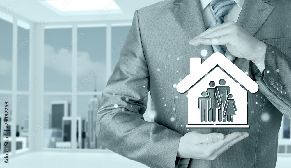 businessman protecting family in home with hands businessman protecting family in home with hands