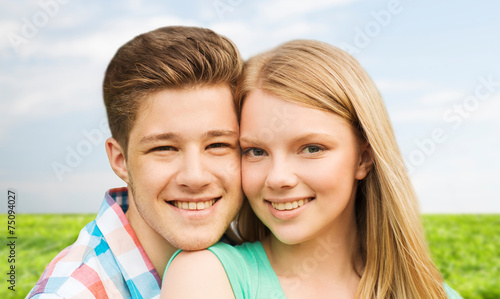smiling couple hugging over natural background © Syda Productions